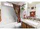 Well-lit bathroom with granite countertops, modern sink, and a shower-tub combo at 20615 N 105Th Ave, Peoria, AZ 85382