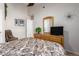 Bedroom with patterned bedding, ceiling fan, and dresser with television at 20615 N 105Th Ave, Peoria, AZ 85382