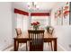 Bright dining room featuring wood table, window with blinds, and wall art at 20615 N 105Th Ave, Peoria, AZ 85382