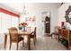 Bright dining room with wood table, chandelier, and view into the kitchen at 20615 N 105Th Ave, Peoria, AZ 85382