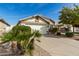 Home featuring a two-car garage with desert landscaping and trees in the front yard at 20615 N 105Th Ave, Peoria, AZ 85382