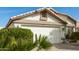 Home with a two-car garage featuring a well-maintained yard with beautiful desert landscaping at 20615 N 105Th Ave, Peoria, AZ 85382