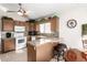 Inviting kitchen featuring granite countertops, wooden cabinets, and modern appliances at 20615 N 105Th Ave, Peoria, AZ 85382