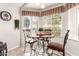 Eat-in kitchen featuring a table with seating and bright natural lighting at 20615 N 105Th Ave, Peoria, AZ 85382
