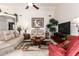 Living room features neutral paint, tile floors, sofas, and a round wooden coffee table at 20615 N 105Th Ave, Peoria, AZ 85382