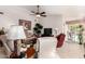 Comfortable living room with sofas, tile floor, ceiling fan, and sliding glass door at 20615 N 105Th Ave, Peoria, AZ 85382