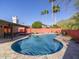 Inviting pool area with desert landscaping, including stone pool surround and mountain views at 2229 E State Ave, Phoenix, AZ 85020