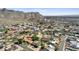 Expansive aerial view of a hillside community with mountain backdrop and variety of houses and swimming pools at 2231 E Orangewood Ave, Phoenix, AZ 85020