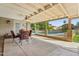 Inviting covered patio with a ceiling fan and view of the pool and outdoor space at 2231 E Orangewood Ave, Phoenix, AZ 85020