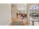 This view showcases hardwood floors leading to the living space, accented by an elegant stone fireplace at 2231 E Orangewood Ave, Phoenix, AZ 85020