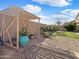 Inviting backyard with a pergola, manicured plants, and gravel landscaping at 22359 W Desert Bloom St, Buckeye, AZ 85326