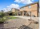 Expansive backyard with a covered patio, well-kept lawn, and gravel areas at 22359 W Desert Bloom St, Buckeye, AZ 85326