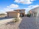 Beautiful single-Gathering home with desert landscaping, a tile roof, and a two-car garage at 22359 W Desert Bloom St, Buckeye, AZ 85326