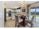 Bright eat-in kitchen featuring stainless steel appliances, white cabinets and modern chandelier at 22359 W Desert Bloom St, Buckeye, AZ 85326