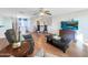 Comfortable living room with stylish furniture, a ceiling fan, and wood flooring at 22359 W Desert Bloom St, Buckeye, AZ 85326