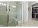 Elegant bathroom featuring a tiled shower with glass doors and a built-in bench at 2477 W Market Pl # 18, Chandler, AZ 85248