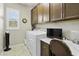 Functional laundry room with storage cabinets, washer, dryer, and a small desk area at 2477 W Market Pl # 18, Chandler, AZ 85248