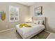 Calm bedroom featuring neutral tones, a comfortable bed, and a large window with plantation shutters at 2477 W Market Pl # 18, Chandler, AZ 85248