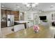 Kitchen and living room with stainless appliances and wood cabinets at 2477 W Market Pl # 18, Chandler, AZ 85248
