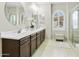 Bathroom featuring double sinks, wood cabinets, and walk-in shower at 2477 W Market Pl # 18, Chandler, AZ 85248