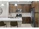 Kitchen featuring an island, stainless steel appliances, and wood cabinets at 2477 W Market Pl # 18, Chandler, AZ 85248