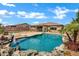 Landscaped backyard with refreshing pool, lush greenery, and patio at 2561 E Toledo Ct, Gilbert, AZ 85295