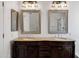Bathroom featuring double sink vanity with elegant mirrors and lighting at 2561 E Toledo Ct, Gilbert, AZ 85295