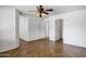 Spacious bedroom with herringbone flooring, multiple doors, and a ceiling fan at 2561 E Toledo Ct, Gilbert, AZ 85295