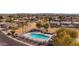 Aerial view of the community pool, perfect for relaxation and recreation, surrounded by a fence and neighborhood homes at 2561 E Toledo Ct, Gilbert, AZ 85295
