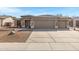 Charming single-story home featuring a three-car garage and desert-style landscaping at 2561 E Toledo Ct, Gilbert, AZ 85295