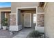 A welcoming front porch with stone accents and a stylish security door at 2561 E Toledo Ct, Gilbert, AZ 85295