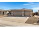 Single-story home featuring a three-car garage with desert-style landscaping and a cement driveway at 2561 E Toledo Ct, Gilbert, AZ 85295