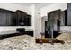 Modern kitchen with black cabinets, granite counters, stainless steel appliances, and a copper sink at 2561 E Toledo Ct, Gilbert, AZ 85295
