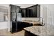Close-up view of a kitchen with black cabinets, granite countertops, and a modern black faucet at 2561 E Toledo Ct, Gilbert, AZ 85295