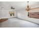 Bright living room with neutral carpet, ceiling fan, chandelier and backyard view at 2561 E Toledo Ct, Gilbert, AZ 85295