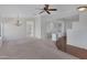 A living room featuring hardwood flooring, a ceiling fan, and an open floor plan at 2561 E Toledo Ct, Gilbert, AZ 85295