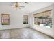Bright living room featuring tile flooring and a view of the backyard pool at 2561 E Toledo Ct, Gilbert, AZ 85295