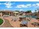 Backyard pool and patio area with a fire pit and comfortable seating at 2561 E Toledo Ct, Gilbert, AZ 85295