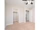 Carpeted bedroom with ceiling fan, closet, and wall mount for TV at 25916 N 161St Ave, Surprise, AZ 85387