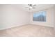 A serene bedroom featuring plush carpeting and a large window for natural light at 25916 N 161St Ave, Surprise, AZ 85387