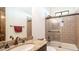 Well-lit bathroom showcasing a granite vanity and a tiled shower with glass doors at 3168 S Yaqui Ln, Gold Canyon, AZ 85118
