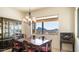 Elegant dining room with scenic views, chandelier, and decorative china cabinet at 3168 S Yaqui Ln, Gold Canyon, AZ 85118