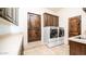 Functional laundry room with modern appliances, ample counter space, and custom cabinetry at 3168 S Yaqui Ln, Gold Canyon, AZ 85118