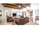 Living room featuring wood beam ceiling, fireplace, and leather seating at 3168 S Yaqui Ln, Gold Canyon, AZ 85118
