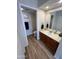 Bathroom with wood floor, vanity with sink, and a framed mirror at 3228 W Glendale Ave # 103, Phoenix, AZ 85051