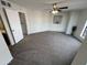 Spacious carpeted bedroom featuring a ceiling fan and neutral paint at 3228 W Glendale Ave # 103, Phoenix, AZ 85051