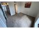 Bedroom with carpet, bathroom access, and modern wall art at 3228 W Glendale Ave # 103, Phoenix, AZ 85051