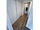 Hallway area with wood floor and closet leading to the bathroom at 3228 W Glendale Ave # 103, Phoenix, AZ 85051
