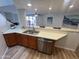 Kitchen showcasing stainless appliances and an open view to the living room and breakfast bar at 3228 W Glendale Ave # 103, Phoenix, AZ 85051