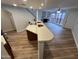 Open concept kitchen with stainless appliances, breakfast bar and view of the living room at 3228 W Glendale Ave # 103, Phoenix, AZ 85051